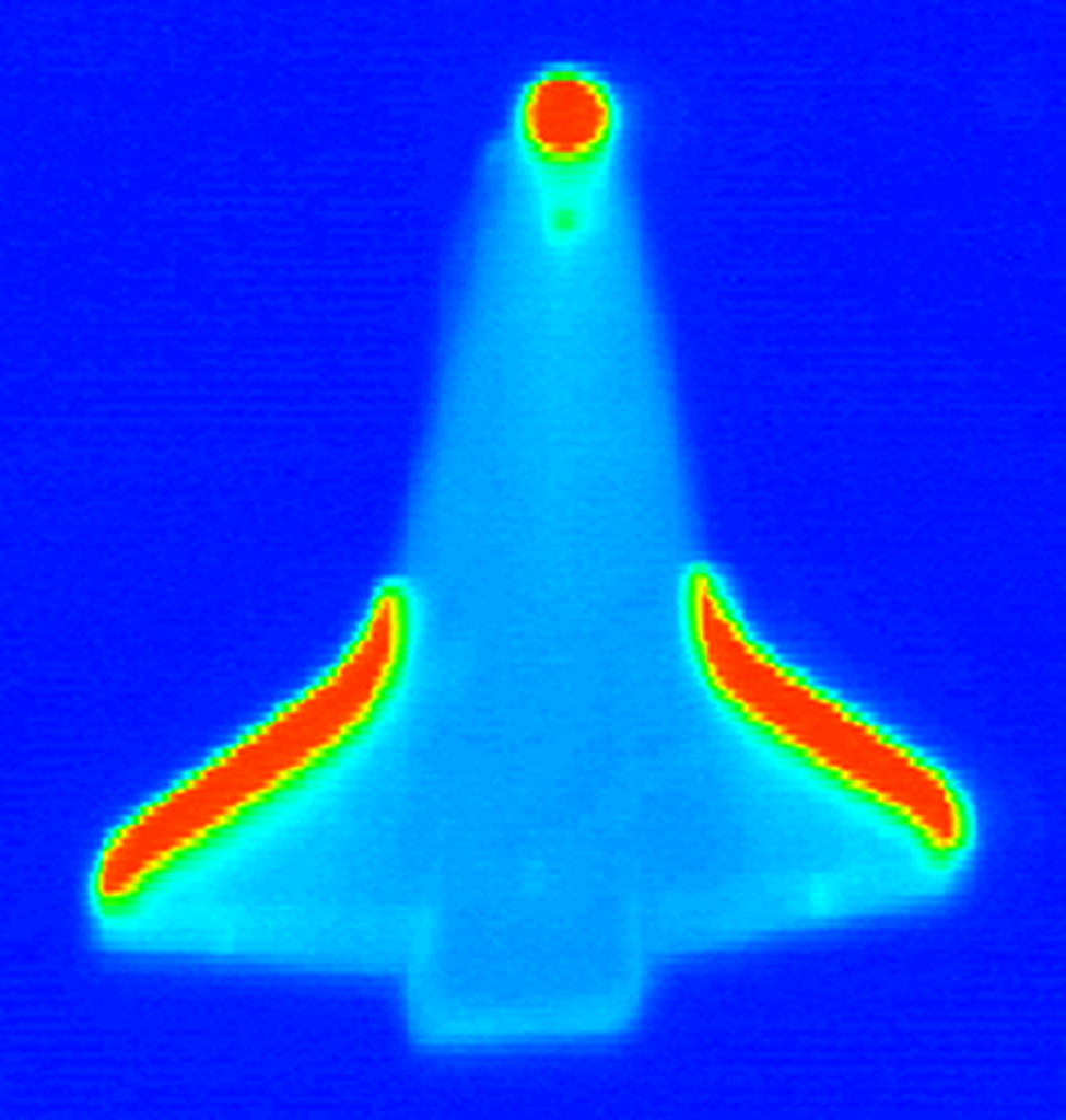 infrared Image of the Space Shuttle in flight showing strong areas of heat at the nose and edges of wings